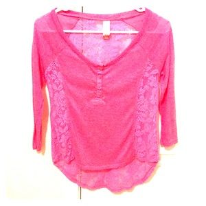 A pink shirt with floral lace from the back/sides